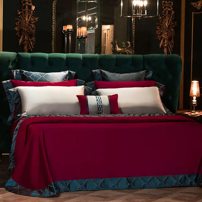 Emerald green tufted velvet headboard with gold accents and mirrored wall in bedroom featuring burgundy 200s egyptian cotton embroidery bedding set