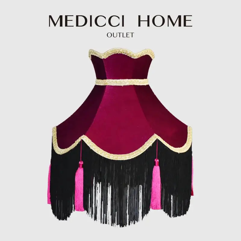 A burgundy wine red velvet scalloped lampshade with gold trim, black fringe, and pink tassels for living room use