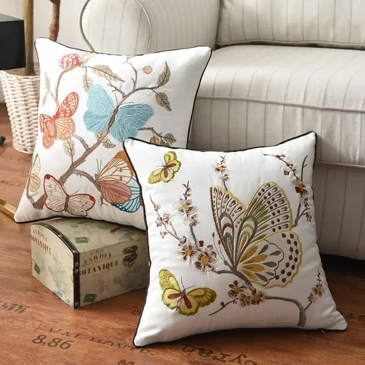 White cotton pillow cover with embroidered butterfly floral design in blue orange green and brown for bedroom decor
