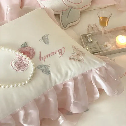 A soft ivory pillow from the decorbites butterfly flowers lace bedding set with pink silver embroidery and satin ruffle