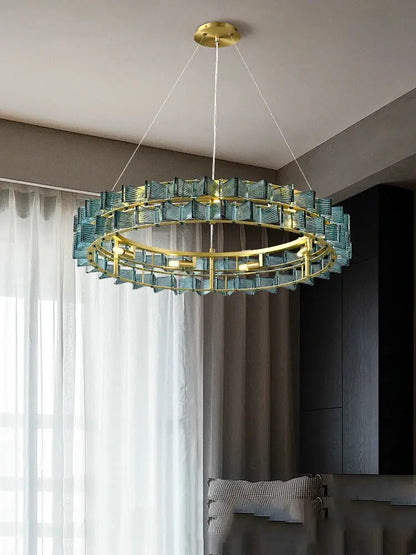 A decorbites butterfly glass chandelier with gold metal frame and teal glass segments for dining room lighting