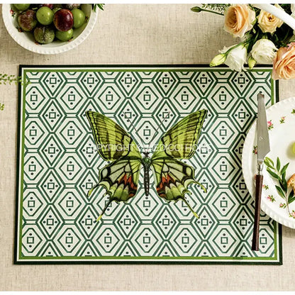 Green and white geometric butterfly print placemat featuring a detailed green butterfly with red accents for decorbites decor