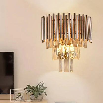 Butterfly tiered gold finish crystal wall sconce with vertical chrome rods and cascading crystal prisms for bedroom lighting