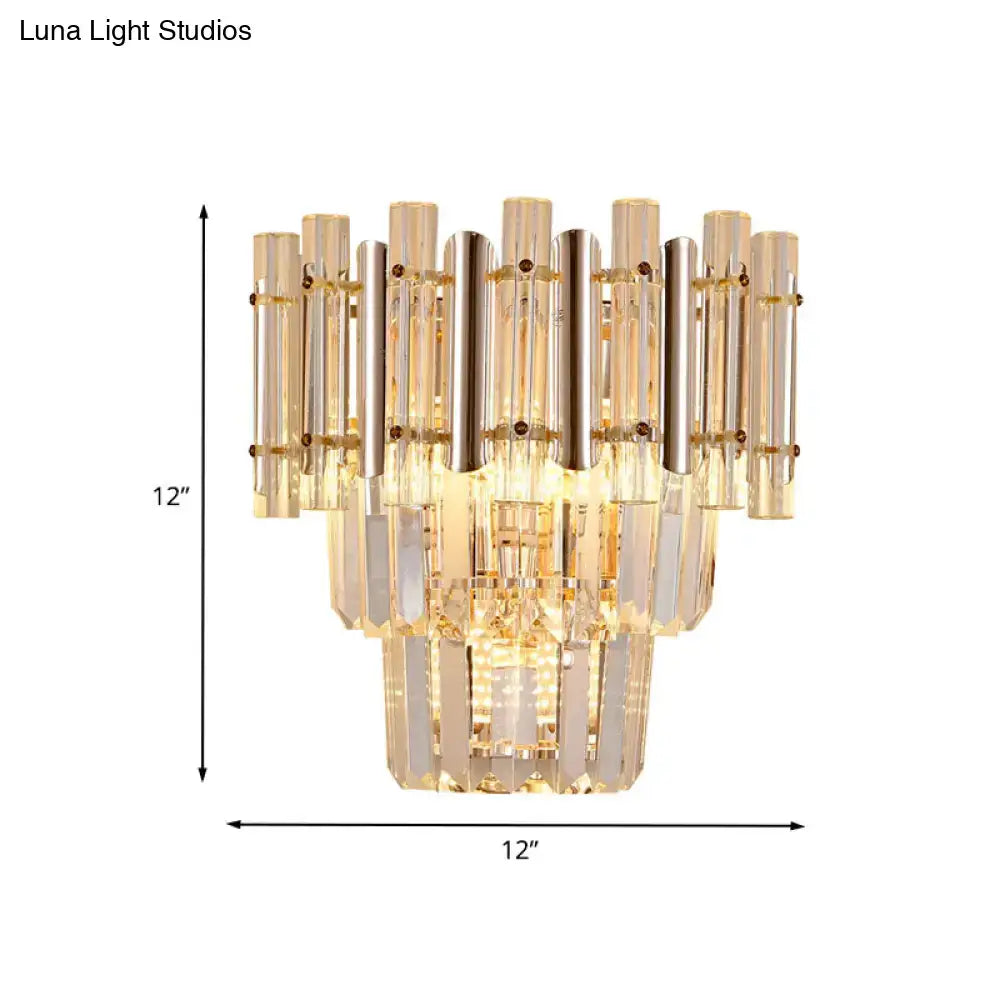 A gold finish butterfly tiered wall sconce with clear and amber glass tubes for bedroom lighting measuring 12 by 12 inches
