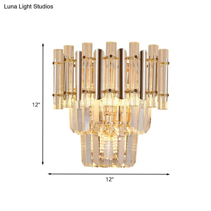 A gold finish butterfly tiered wall sconce with clear and amber glass tubes for bedroom lighting measuring 12 by 12 inches