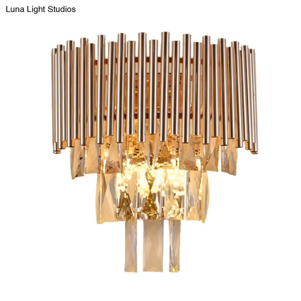 Butterfly tiered gold finish crystal wall sconce with vertical metallic rods and cascading faceted crystals for bedroom lighting