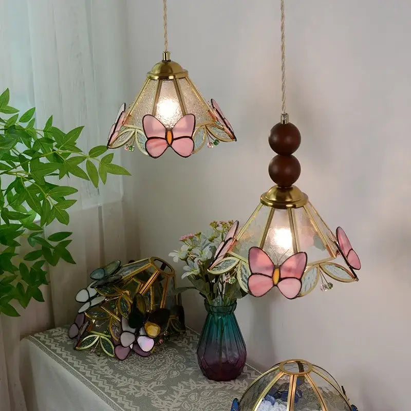 Two hanging butterfly tiffany glass pendant lights with golden frames and pink motifs for dining room decorbites butterfly tiffany
