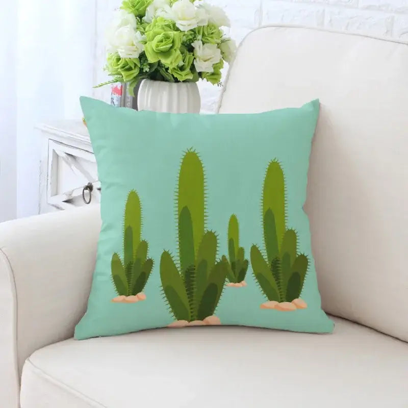 A mint green decorative pillowcase with decorbites cactus hand painting of several cacti and beige rocks for sofa decor