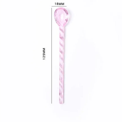 A translucent pink glass stirring spoon with a twisted handle measuring 125mm for decorbites colorful glass set