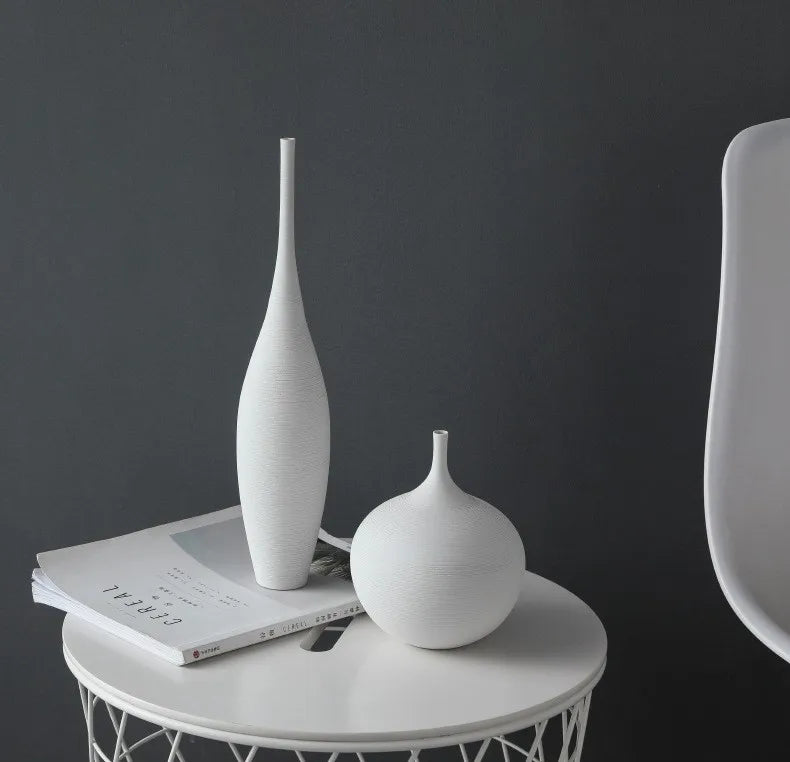 White ceramic capiron zen vases with sleek minimalist design on white side table for nordic home decoration centerpiece