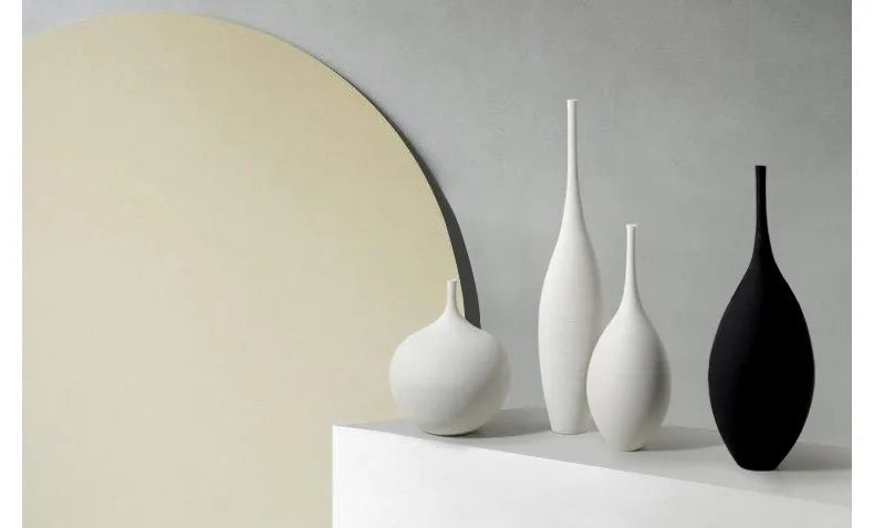 Minimalist capiron zen ceramic vases in sleek white and glossy black with elongated necks for modern home decoration