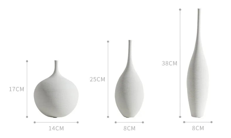 Three minimalist white ceramic vases of varying heights and slender shapes for zen home decoration and living room centerpiece