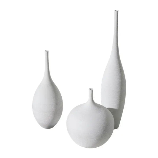 Set of three white ceramic vases with textured surfaces and slender necks for nordic home decoration by capiron