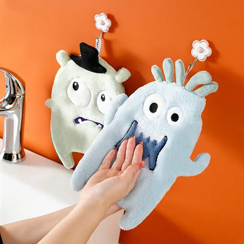 Blue coral velvet cartoon animal hand towel shaped like a plush monster with embroidered eyes and flower hooks