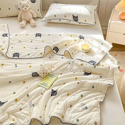 Cream-colored quilted kids summer quilt with black cat and polka dots featuring soft cotton texture by decorbites kids