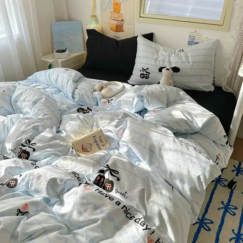 Light blue satin quilt cover set with black cherry and bow prints featuring have a nice day playful lettering