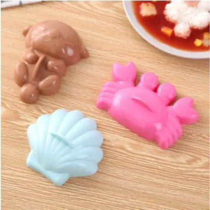 Cartoon animal sushi mold set with three colorful silicone molds in brown bear pink crab and light blue seashell shapes