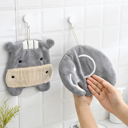 Gray plush hippo-shaped hand towel with beige snout and white embroidered details from decorbites cartoon animals coral collection