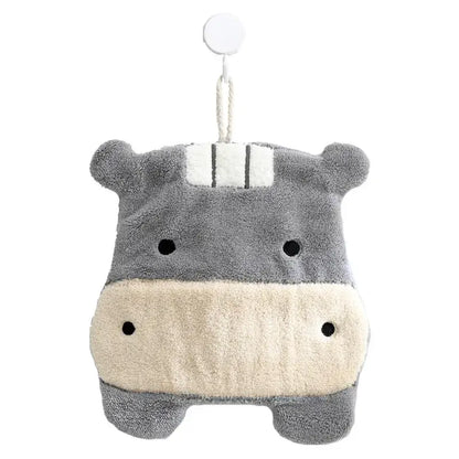 Gray and cream plush hippo hand towel with black embroidered eyes and white striped headband hanging on hook decorbites cartoon animals coral