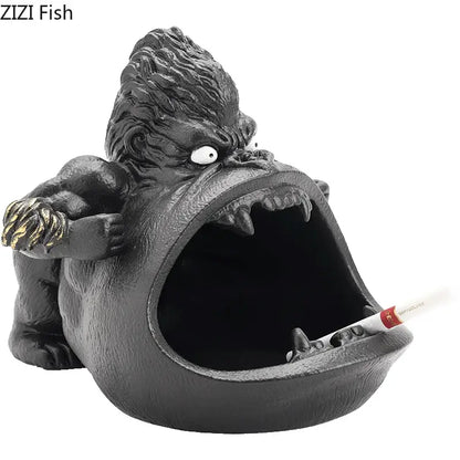 Black gorilla ceramic ashtray with textured fur and gold-accented claws holding a cigarette for living room decorbites decor