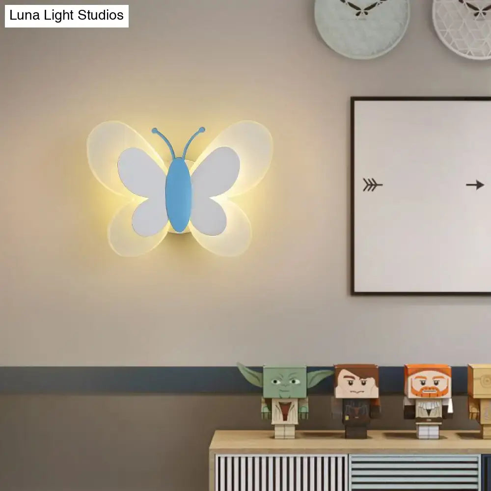 Cartoon blue and gray butterfly led wall light with translucent white wings emitting warm glow for kindergarten use