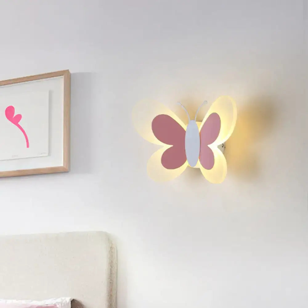 A soft pink and white butterfly-shaped led wall lamp with a glowing translucent design for kindergarten use