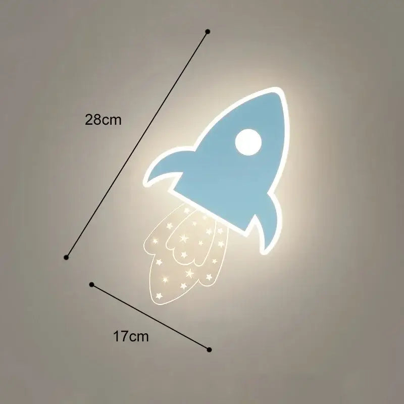 Cartoon wall lamp shaped like a blue rocket with glowing white outline and star-patterned tail for bedroom decor