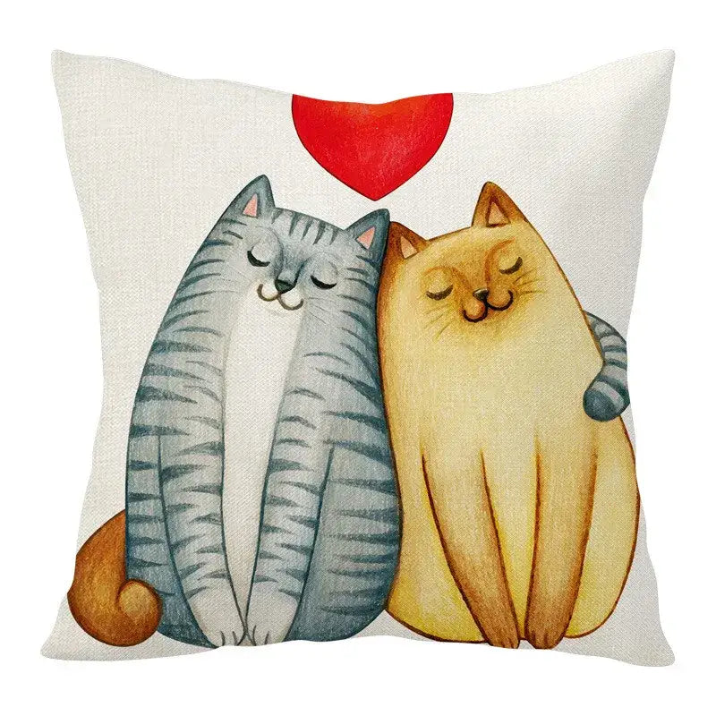 White linen throw pillow with decorbites cartoon cat linen design of two affectionate cats under a red heart