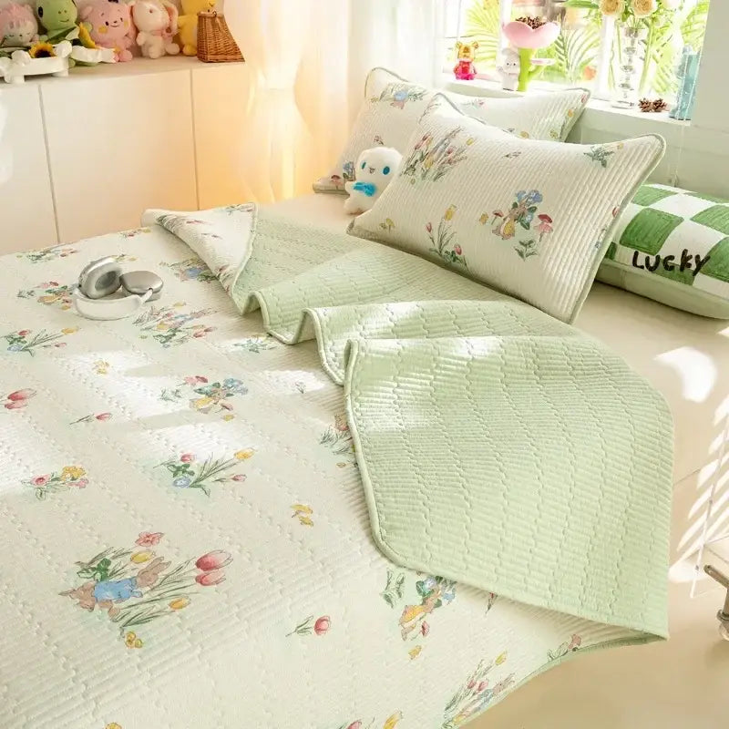 Pastel green quilted cotton bed cover set with delicate floral and bunny pattern for bedroom use