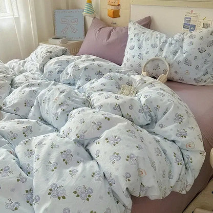 Light blue floral-patterned fitted sheet set with quilted texture and pastel accents for bedroom bedding use