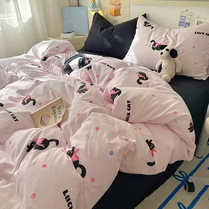 Pink duvet cover featuring black cats with pink bows and polka dots as part of a cartoon dog and cupcake fitted sheet set
