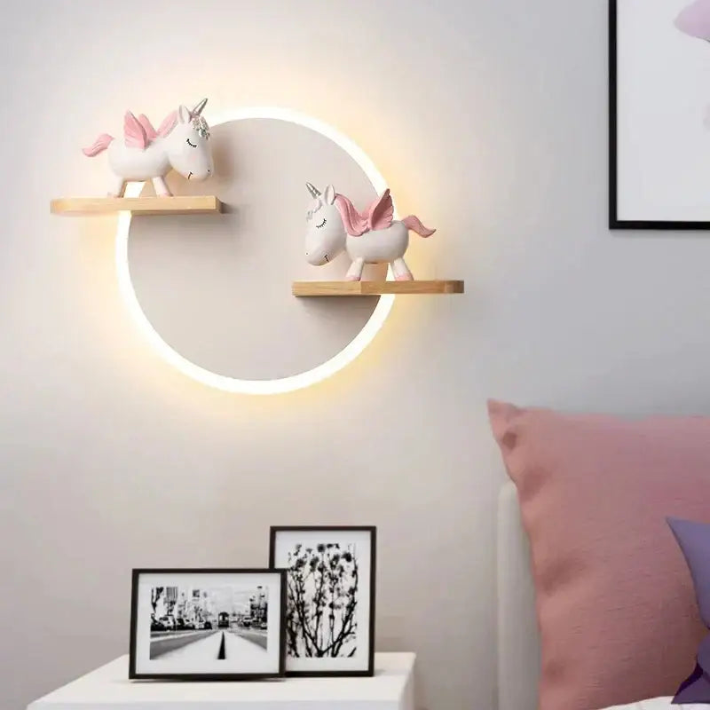 Circular led wall lamp with warm glow and wooden shelves holding pink and white unicorn figurines for bedroom decorbites led wall