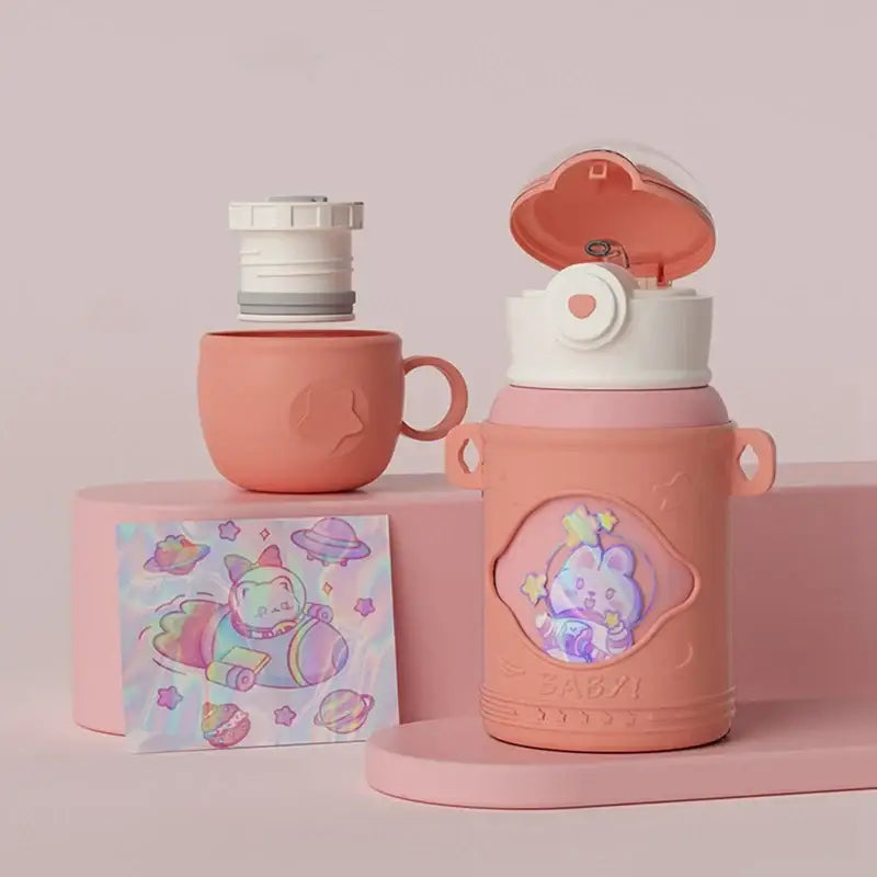 Pink silicone-covered stainless steel thermal water bottle with white lid and cartoon rabbit for kitchen use