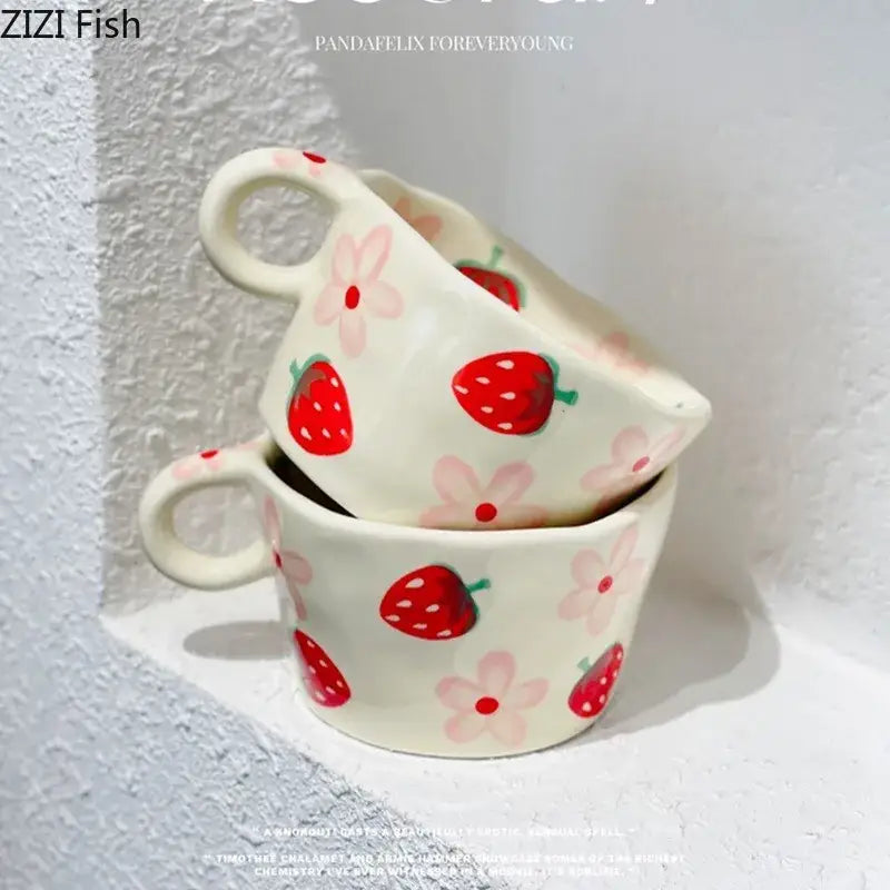 Cream-colored ceramic mug set with decorbites cartoon pattern featuring hand-painted red strawberries and pink flowers