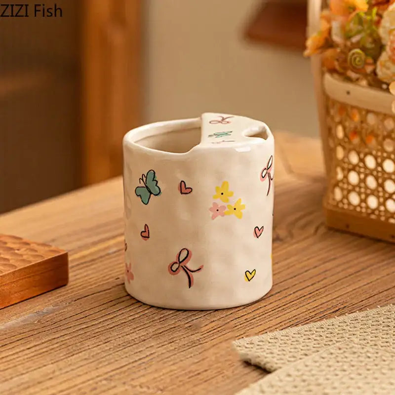 A white ceramic cartoon pattern porcelain toothbrush holder featuring pastel butterflies hearts and flowers for bathroom decor