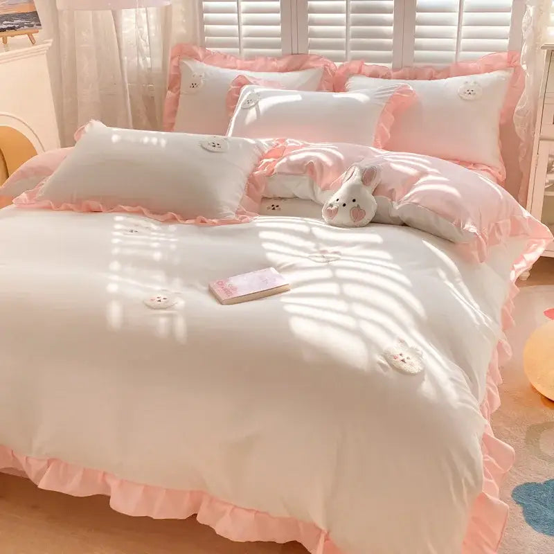 Pink ruffled bedding set with white pillows and embroidered bunny appliqués from decorbites cartoon princess collection
