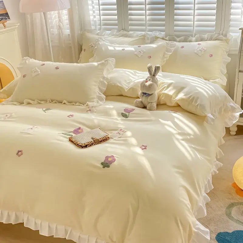 Cream-colored satin bedding set with delicate ruffles and embroidered floral patterns for decorbites cartoon princess bedroom