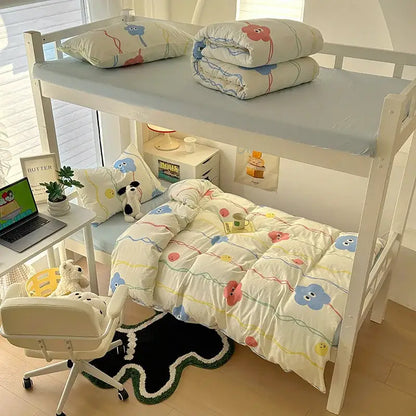 White bunk bed with decorbites cartoon printed bedding sets featuring colorful cloud and balloon patterns in cream and blue