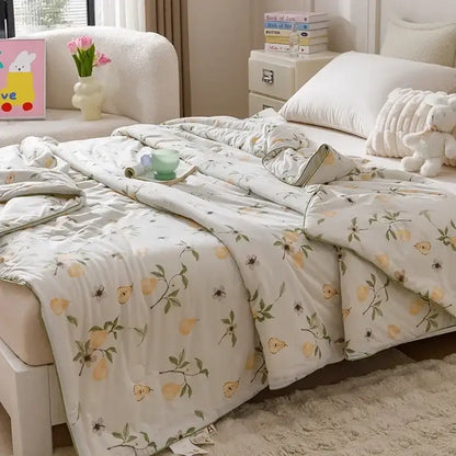 Off white cooling summer blanket quilt with yellow pear pattern and green leaves ideal for summer use