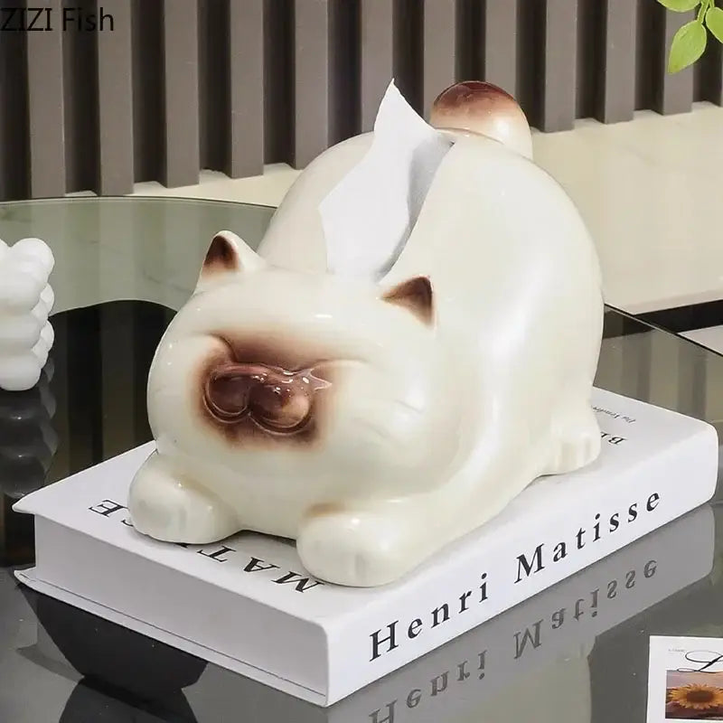 Cream-colored ceramic tissue box shaped like a sleeping cartoon siamese kitten with brown accents for decorbites decor
