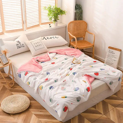 White and pink cotton quilted double blanket with strawberry pattern and soft plush texture for bedroom use
