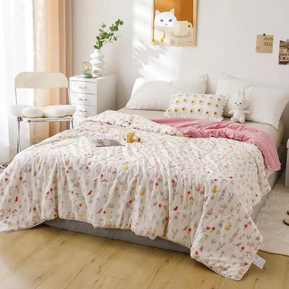 A soft off-white quilted double blanket with pastel floral and insect pattern for bedroom use