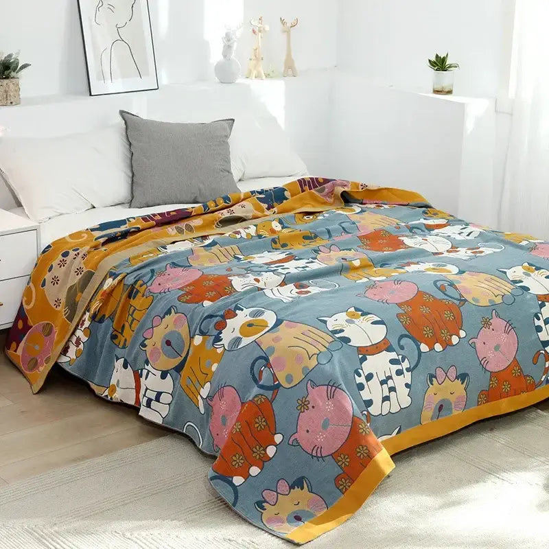 A decorbites cartoon throw blanket with soft texture featuring colorful cartoon cats on light blue with yellow trim