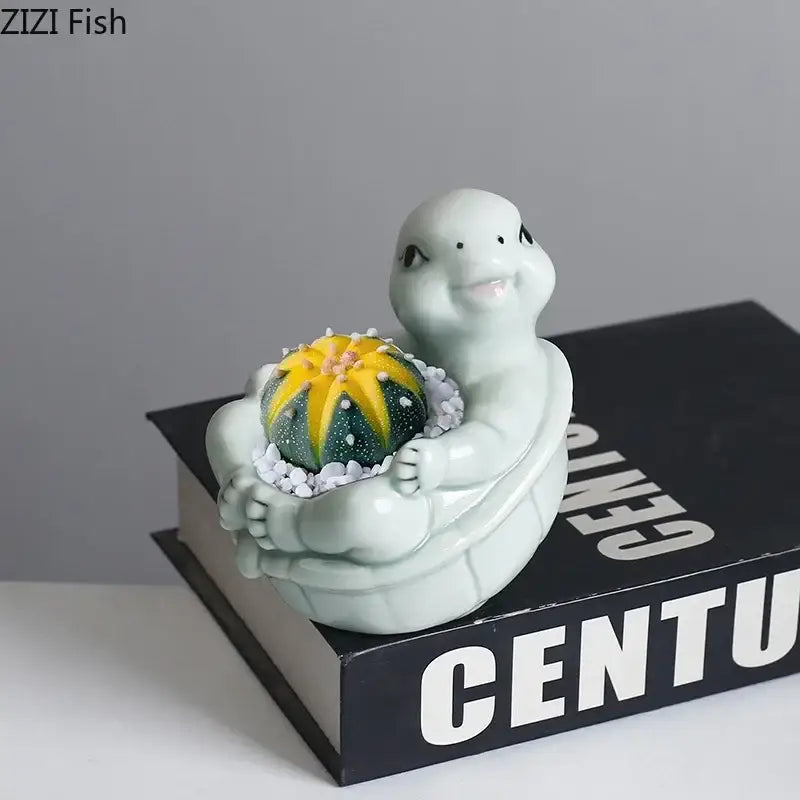 A light green cartoon turtle ceramic flower vase featuring a vibrant yellow and green cactus for living room decor