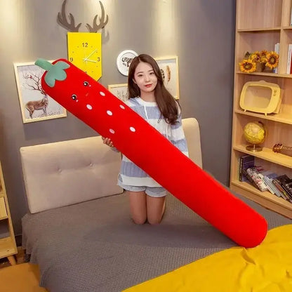 A plush red strawberry-shaped decorbites comfort long body pillow with white polka dots and green leafy top for bedroom decor