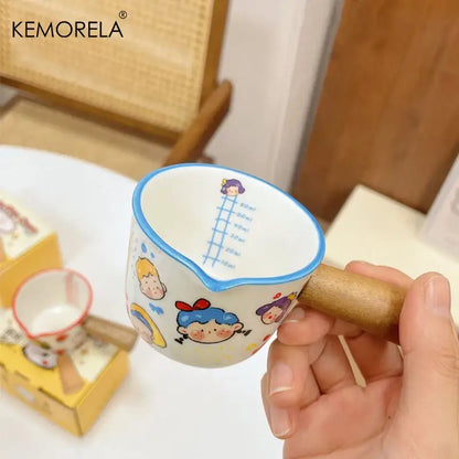 A white italian ceramic measuring cup with wooden handle and colorful cartoon decorbites italian ceramic design