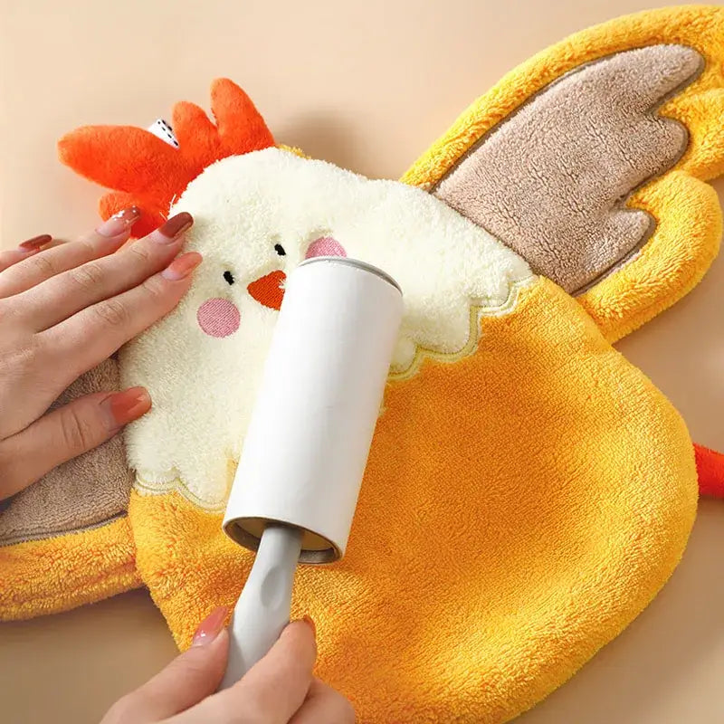 White lint roller with gray handle used on coral velvet cartoon yellow and white chicken hand towel decorbites decor
