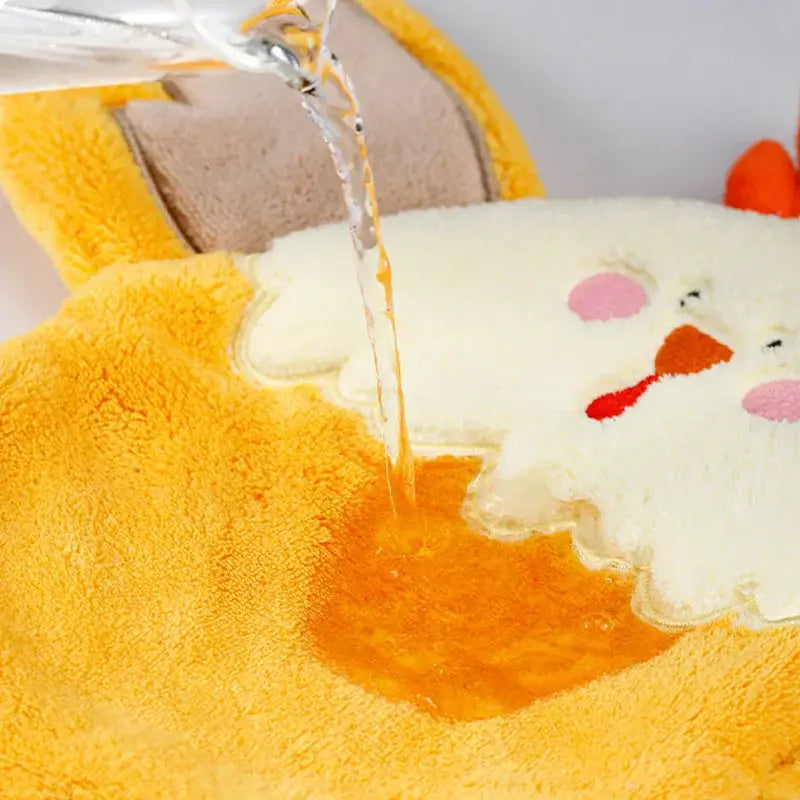 Yellow plush chick-shaped hand towel with pink cheeks and orange beak made of decorbites coral velvet for kitchen decor