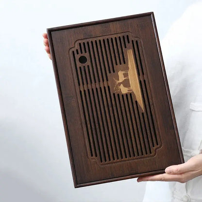 Dark brown bamboo tea tray with vertical slats and carved golden deer for dining room drainage board use