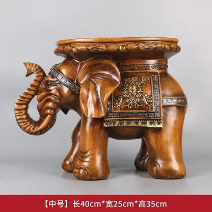 Brown wooden elephant wealth attracting stool with intricate carvings and metallic embellishments for living room